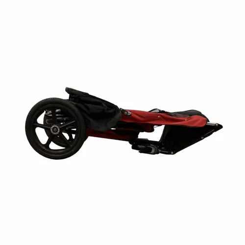 Folded red stroller with black wheels for easy storage and transport