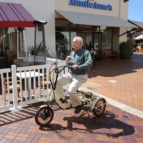 Elderly_Holding_a_Cup_of_Coffee_While_Riding_a_Transit_750W_Folding_Electric_Trike