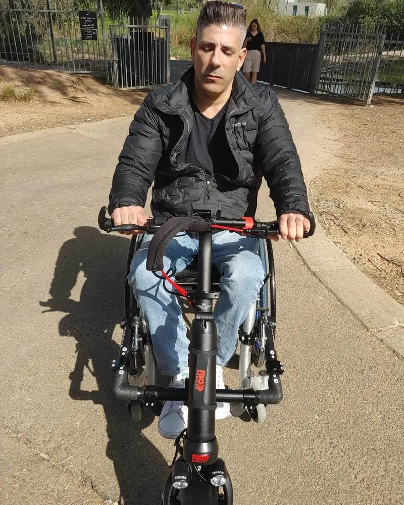 Wheelchair user out and about with the Rio Firefly attachment
